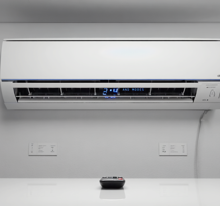 Gen4 Realistic close-up of a wall-mounted AC unit with its remote placed on a white t a-2, 188493975